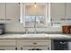 Bright kitchen sink with stainless steel appliances, undermount sink, and window with view at 2200 Teller St, Lakewood, CO 80214
