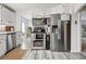 Bright kitchen with stainless steel appliances, including microwave, oven, and refrigerator at 2200 Teller St, Lakewood, CO 80214