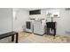 Convenient laundry room features modern appliances, extra storage, and sink at 2200 Teller St, Lakewood, CO 80214