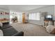 Open-concept view of a living room and dining room with a harmonious color palette at 2200 Teller St, Lakewood, CO 80214