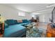Cozy living space with bright blue sectional and natural light at 2200 Teller St, Lakewood, CO 80214