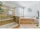Relaxing bathroom with a glass-enclosed shower and a separate soaking tub at 25402 E Glasgow Pl, Aurora, CO 80016