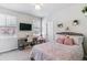 Cozy bedroom with a decorative bed, desk, and ample natural light at 25402 E Glasgow Pl, Aurora, CO 80016
