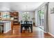 Light-filled dining room boasts wood floors, a modern chandelier, and sliding glass doors at 25402 E Glasgow Pl, Aurora, CO 80016