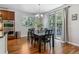 Cozy dining area featuring wood floors, ample natural light, and access to outdoor area at 25402 E Glasgow Pl, Aurora, CO 80016
