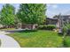 Charming home with a well-manicured front lawn, mature trees, and a welcoming driveway at 25402 E Glasgow Pl, Aurora, CO 80016