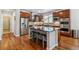 Gourmet kitchen with stainless steel appliances, dark wood cabinetry, and a spacious center island with seating at 25402 E Glasgow Pl, Aurora, CO 80016