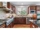 Well-equipped kitchen features stainless steel appliances, granite counters and wood cabinets at 25402 E Glasgow Pl, Aurora, CO 80016