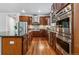 Modern kitchen featuring stainless steel appliances, dark wood cabinetry, and hardwood floors at 25402 E Glasgow Pl, Aurora, CO 80016