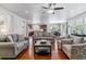 Spacious living room with hardwood floors, stone fireplace, and an open layout connecting to the kitchen at 25402 E Glasgow Pl, Aurora, CO 80016