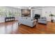 Bright living room showcasing hardwood floors, a stone fireplace, and ample natural light at 25402 E Glasgow Pl, Aurora, CO 80016