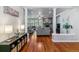 Bright living room with hardwood floors, decorative columns, and a cozy stone fireplace at 25402 E Glasgow Pl, Aurora, CO 80016