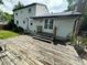 Spacious wooden deck provides outdoor living with a view of the home's white siding and lawn at 7431 Webster St, Arvada, CO 80003