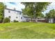 Large backyard features a green lawn, deck, shed and white siding at 7431 Webster St, Arvada, CO 80003