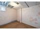 Unfinished basement includes carpeted floors, window, and exposed ceiling at 7431 Webster St, Arvada, CO 80003