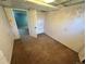 Unfinished basement featuring neutral carpet, primed walls, and a view into another room at 7431 Webster St, Arvada, CO 80003