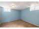 Unfinished basement with carpeted floors, windows, and painted walls at 7431 Webster St, Arvada, CO 80003