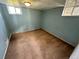 Carpeted basement room features blue walls and two small windows at 7431 Webster St, Arvada, CO 80003
