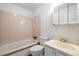 This well-lit bathroom includes a tub, toilet, and sink at 7431 Webster St, Arvada, CO 80003