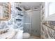 A charming bathroom features a tub/shower combo and unique wallpaper for added character at 7431 Webster St, Arvada, CO 80003