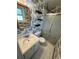 Small bathroom features wallpaper, a glass shower, sink, and toilet at 7431 Webster St, Arvada, CO 80003