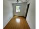 Smaller room with laminate flooring, white walls, a ceiling fan, closet, and a window at 7431 Webster St, Arvada, CO 80003