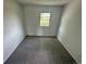 Small bedroom with neutral carpeting, white walls, and a single window at 7431 Webster St, Arvada, CO 80003