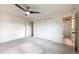 This bedroom has a fan, carpeting and a bathroom connected with an open door at 7431 Webster St, Arvada, CO 80003
