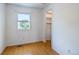 Bright bedroom features wood floors, window, and closet entrance at 7431 Webster St, Arvada, CO 80003