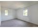 A bright bedroom features neutral carpet and dual windows offering ample natural light at 7431 Webster St, Arvada, CO 80003