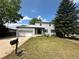 Charming two-story home featuring a well-maintained lawn, attached garage, and classic curb appeal at 7431 Webster St, Arvada, CO 80003