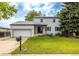 Charming two-story home with a well-maintained lawn and an attached garage at 7431 Webster St, Arvada, CO 80003