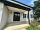 Welcoming front entrance with a covered porch and modern lighting fixtures, enhancing its curb appeal at 7431 Webster St, Arvada, CO 80003