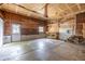 Spacious garage with concrete floor, wood walls, and white door ready to be transformed into a functional space at 7431 Webster St, Arvada, CO 80003