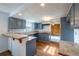 Functional kitchen with updated cabinets, breakfast bar and adjacent room at 7431 Webster St, Arvada, CO 80003