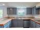 Functional kitchen with updated cabinets, and stainless steel dishwasher at 7431 Webster St, Arvada, CO 80003