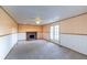 A spacious living room features a brick fireplace and double doors leading to the outside at 7431 Webster St, Arvada, CO 80003