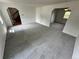 Open-concept living area with fresh carpeting and views into dining and staircase, perfect for entertaining at 7431 Webster St, Arvada, CO 80003