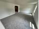 Bright, neutral living room with gray carpeting and ample natural light, ready for your personal touch at 7431 Webster St, Arvada, CO 80003