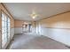 The living room features neutral carpeting and access to the kitchen, offering a versatile space at 7431 Webster St, Arvada, CO 80003