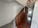 Carpeted stairway with wood railing and wood wall paneling leads to the second floor at 7431 Webster St, Arvada, CO 80003