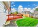 A well-maintained backyard with a wood deck, a grassy lawn, and an attractive stone pathway at 12287 W Aqueduct Dr, Littleton, CO 80127