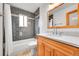 Modern bathroom with gray subway tile shower, neutral vanity, and contemporary fixtures at 12287 W Aqueduct Dr, Littleton, CO 80127