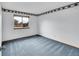 Cozy bedroom featuring blue carpet, white walls, and a window with natural light at 12287 W Aqueduct Dr, Littleton, CO 80127
