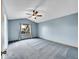 Serene bedroom with vaulted ceiling, neutral walls, and large window allowing natural light at 12287 W Aqueduct Dr, Littleton, CO 80127