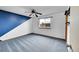 Bright bedroom with blue accent wall, ceiling fan, and window view of surrounding houses at 12287 W Aqueduct Dr, Littleton, CO 80127