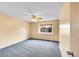 Bedroom with neutral walls, standard window, a ceiling fan, and neutral carpeting at 12287 W Aqueduct Dr, Littleton, CO 80127