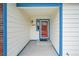 Inviting entryway featuring a red front door, sidelight window and brick accents at 12287 W Aqueduct Dr, Littleton, CO 80127