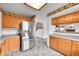 Spacious kitchen featuring stainless steel refrigerator and views to staircase and dining at 12287 W Aqueduct Dr, Littleton, CO 80127