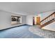 Inviting living room with staircase, a large window, and tiled entryway at 12287 W Aqueduct Dr, Littleton, CO 80127